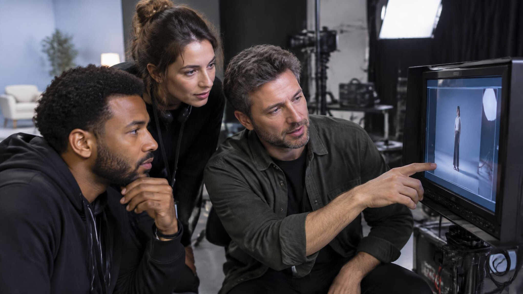 Production team reviewing camera footage together